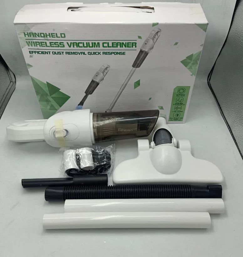 Handheld wireless vacuum cleaner with accessories on a white surface, featuring a green box in the background.