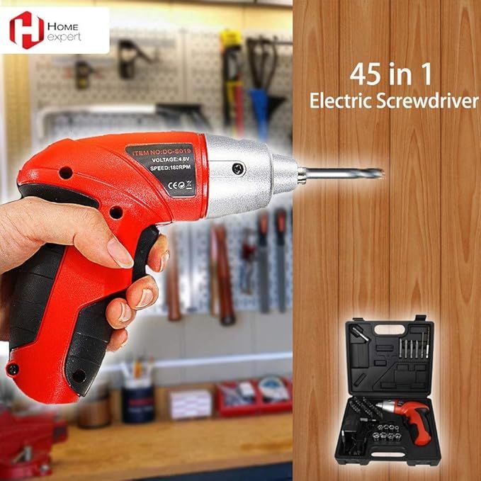 Red and black electric screwdriver with accessories on a wooden surface, set against a workshop background.