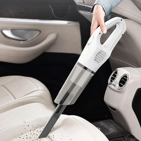 Handheld vacuum cleaner being used to clean a car seat.